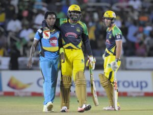 Chris Gayle (R) of Jamaica Tallawahs hug Fidel Edwards (L)