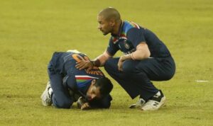 Navdeep Saini holds his arm in pain as Shikhar Dhawan attends to him, during the second Sri Lanka-India T20I on Wednesday. - AP