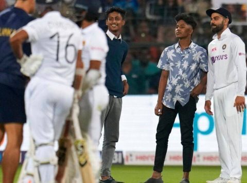 A fan managed to breach the security to enter the field and click selfie with Virat Kohli during Day 2 play of second Test in Bengaluru. AP Photo/Aijaz Rahi