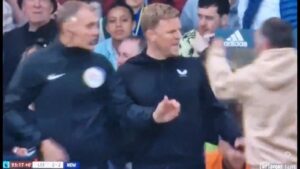Eddie Howe being shoved by the pitch invader